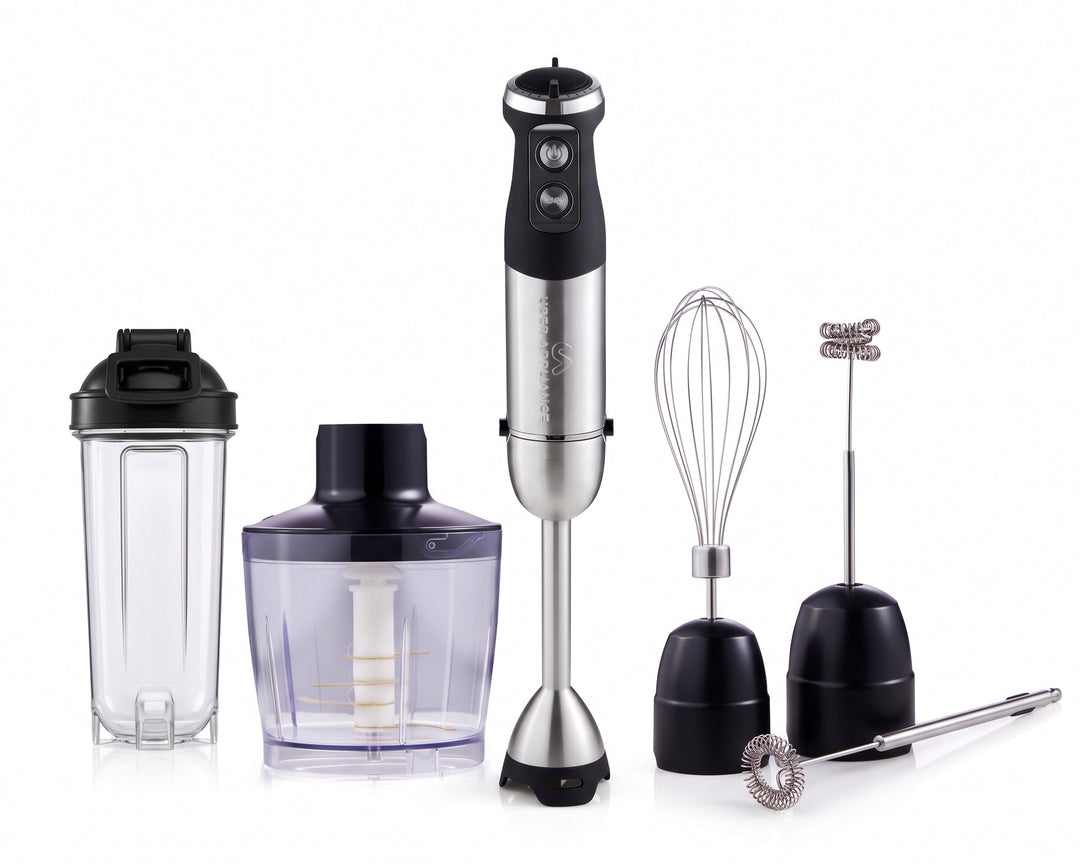 An immersion blender set with a silver and black hand blender, a clear blending jar, a purple food chopper attachment, a wire whisk, a metal milk frother, and a black milk pitcher on a white background.